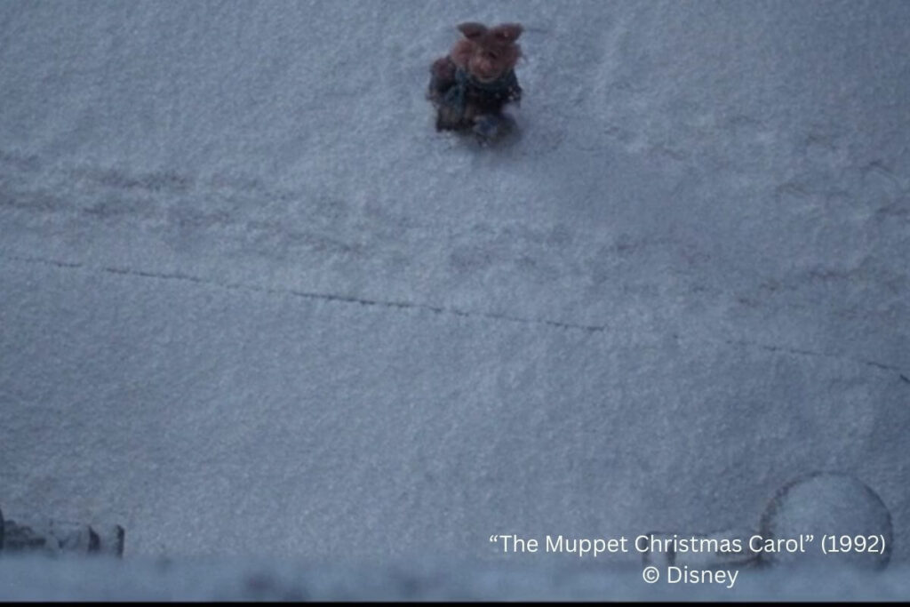 overhead image of footprints in the snow of a screen shot from the Muppet Christmas Carol movie.