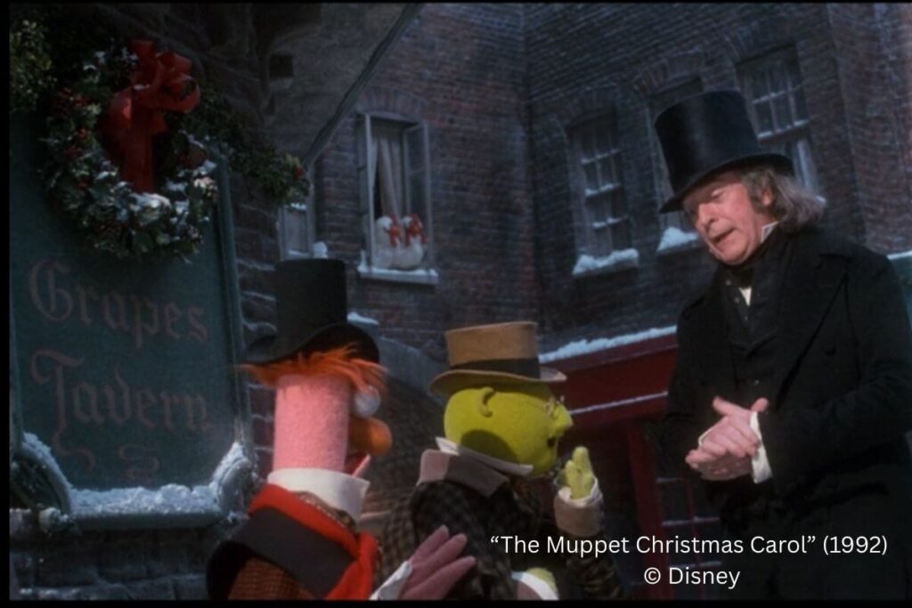 michael caine talking to Beaker and Dr. Bunsen Honeydew in front of a sign named "The Pigs and Grapes Tavern".