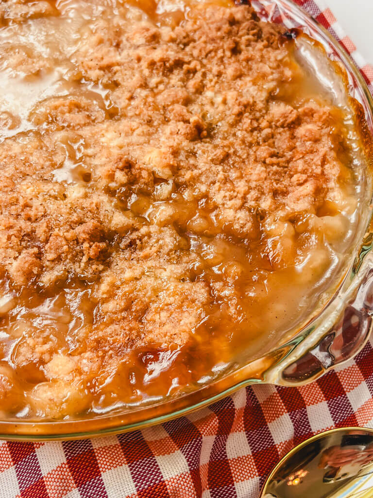 close up of peach crumble in a pie dish
