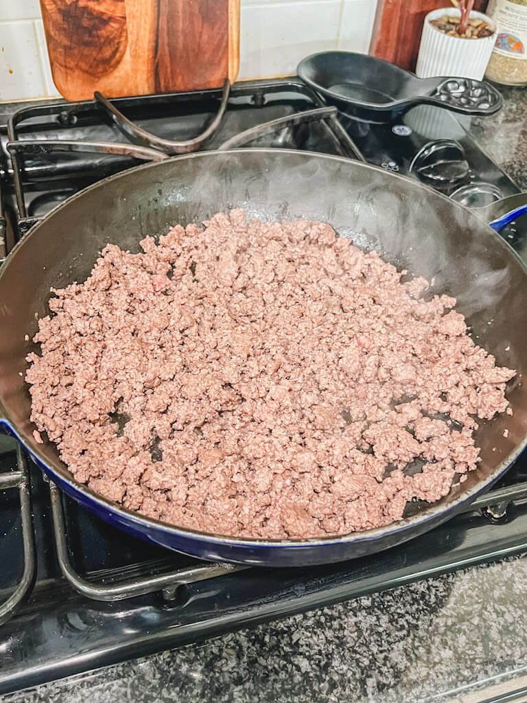 ground beef being browned in a large skillet.