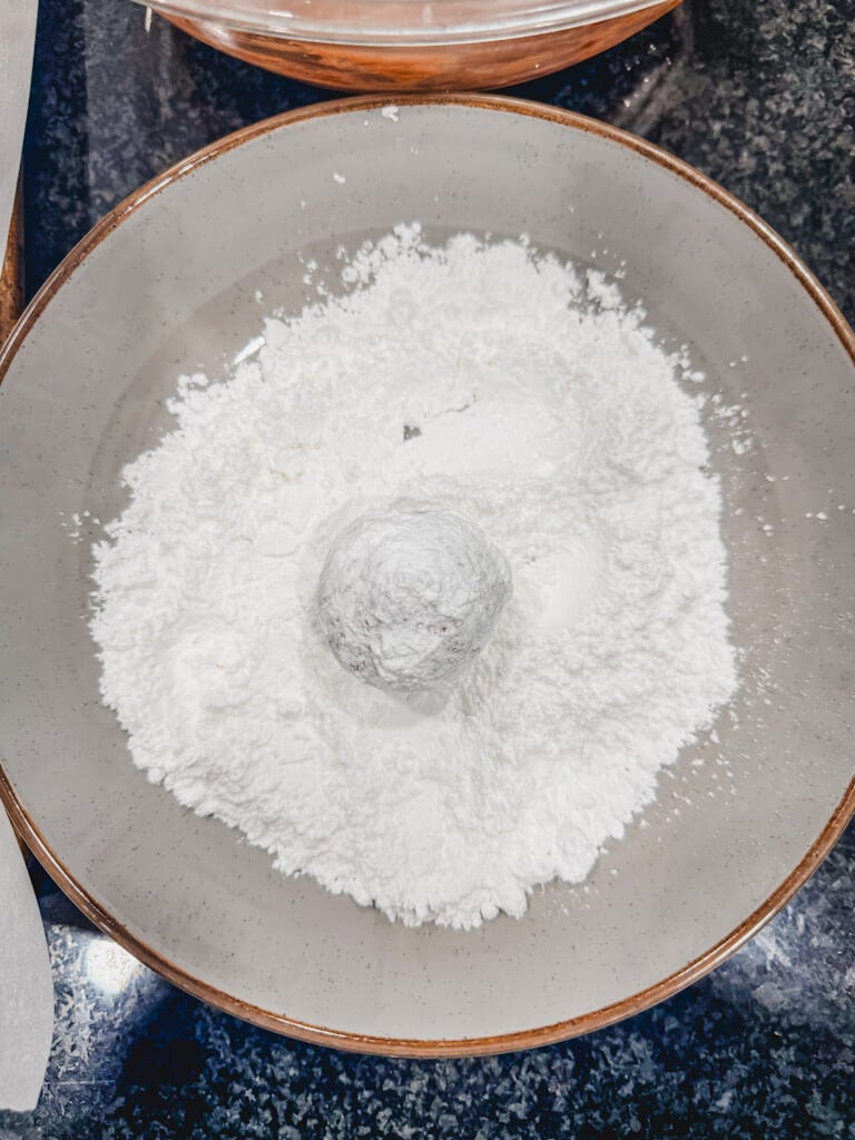 cookie dough balls rolled in powdered sugar a second time.