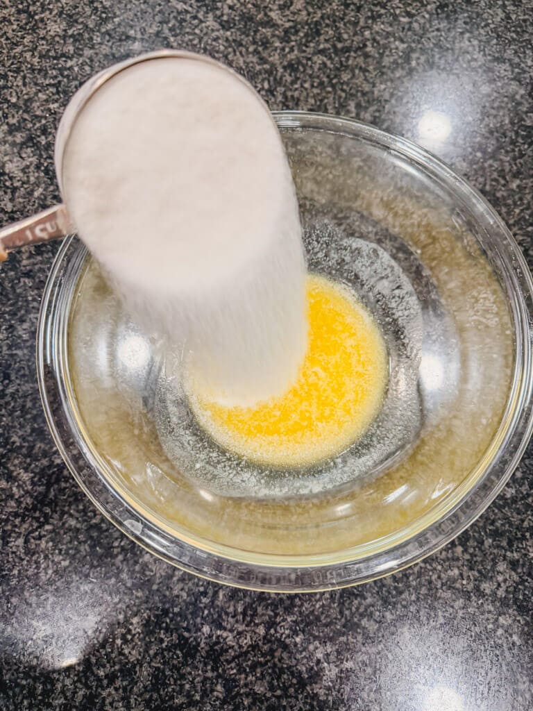 A cup of sugar added to the melted butter.