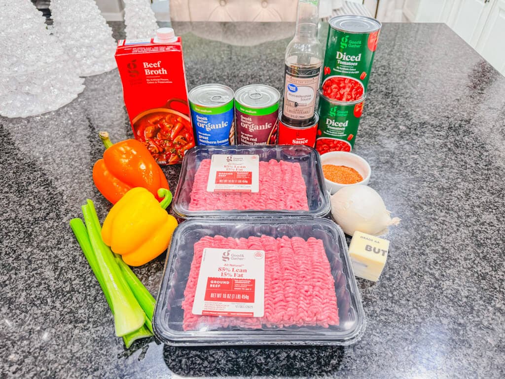 ingredients laid out on a black counter top for chili beans recipe.