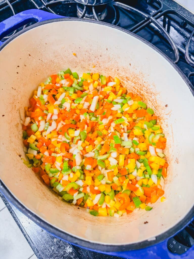 Diced bell peppers, celery, and onions added to the melted butter in the Dutch oven for Chili Beans.