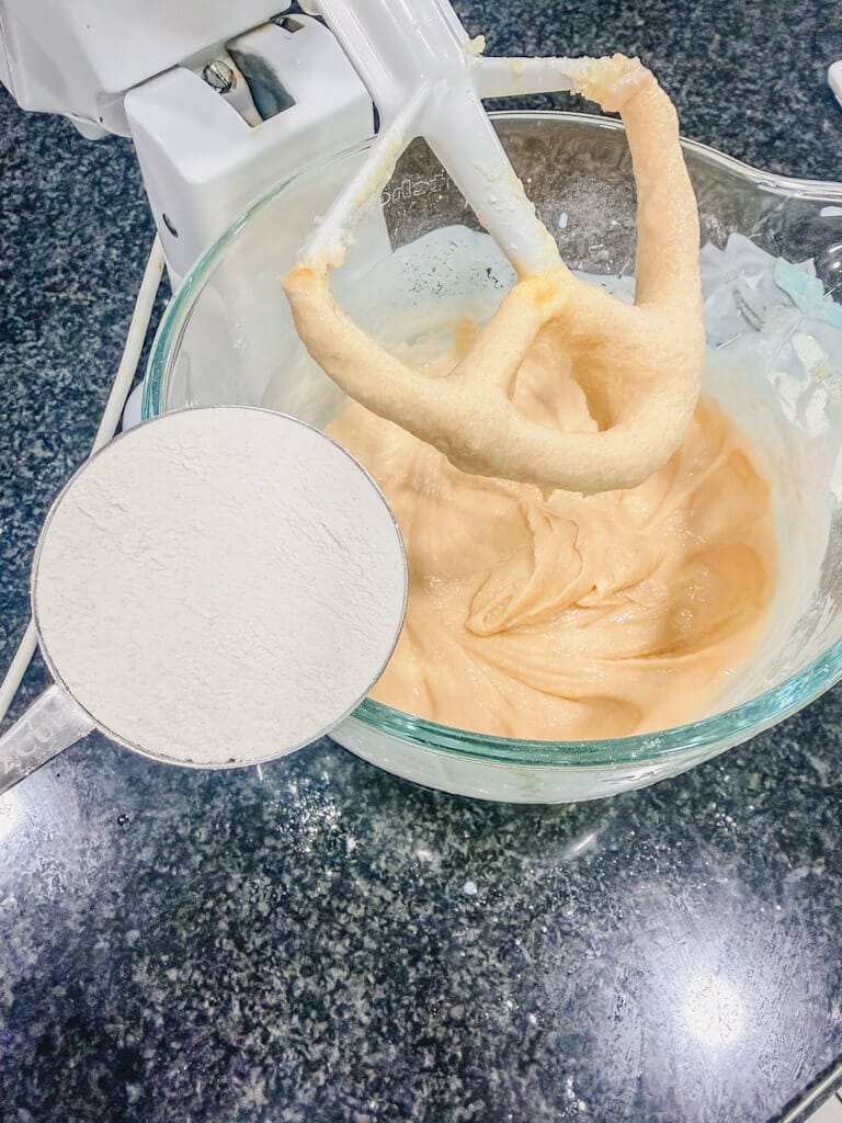 the remaining 1/2 cup of flour about to be added to the mixing bowl.