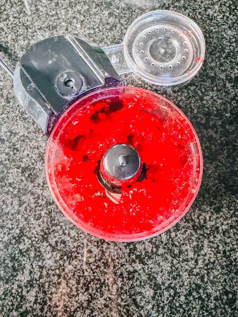 Cherries chipped in a small food processor about to be added to the cake mix.
