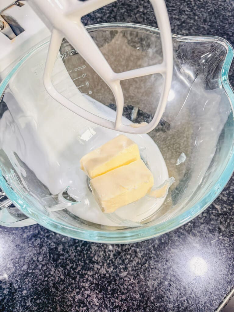 softened butter in a glass mixing bowl.