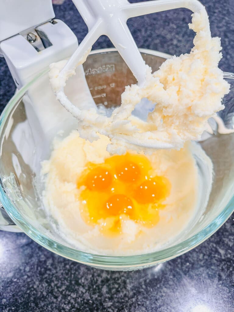 Four room temperature eggs added to the creamed butter and sugar.