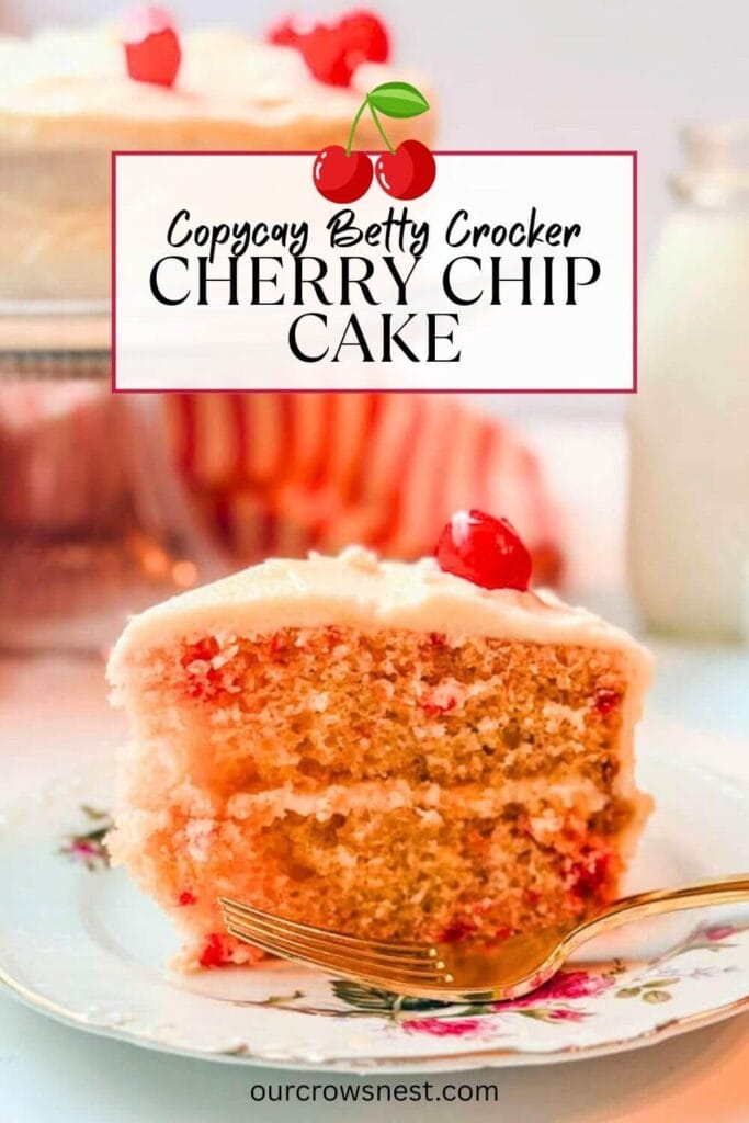 A slice of Cherry Chip cake on a a plate next to a fork with the rest of the cake in the background.