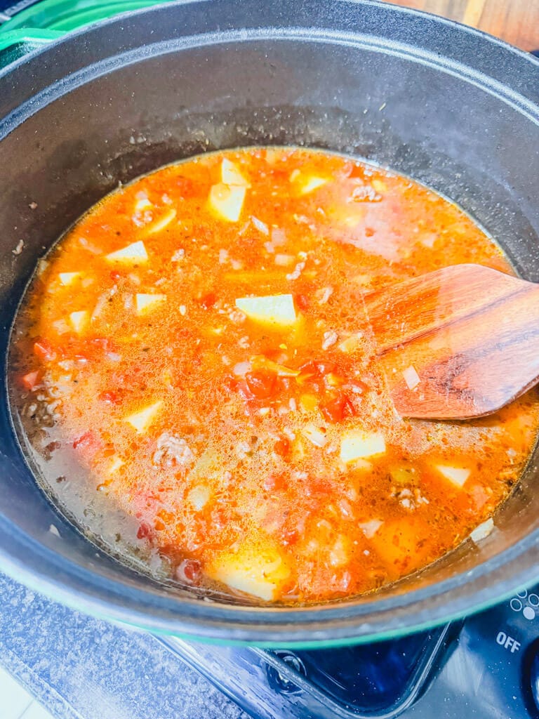 Ground beef chile stew simmering in the pot.