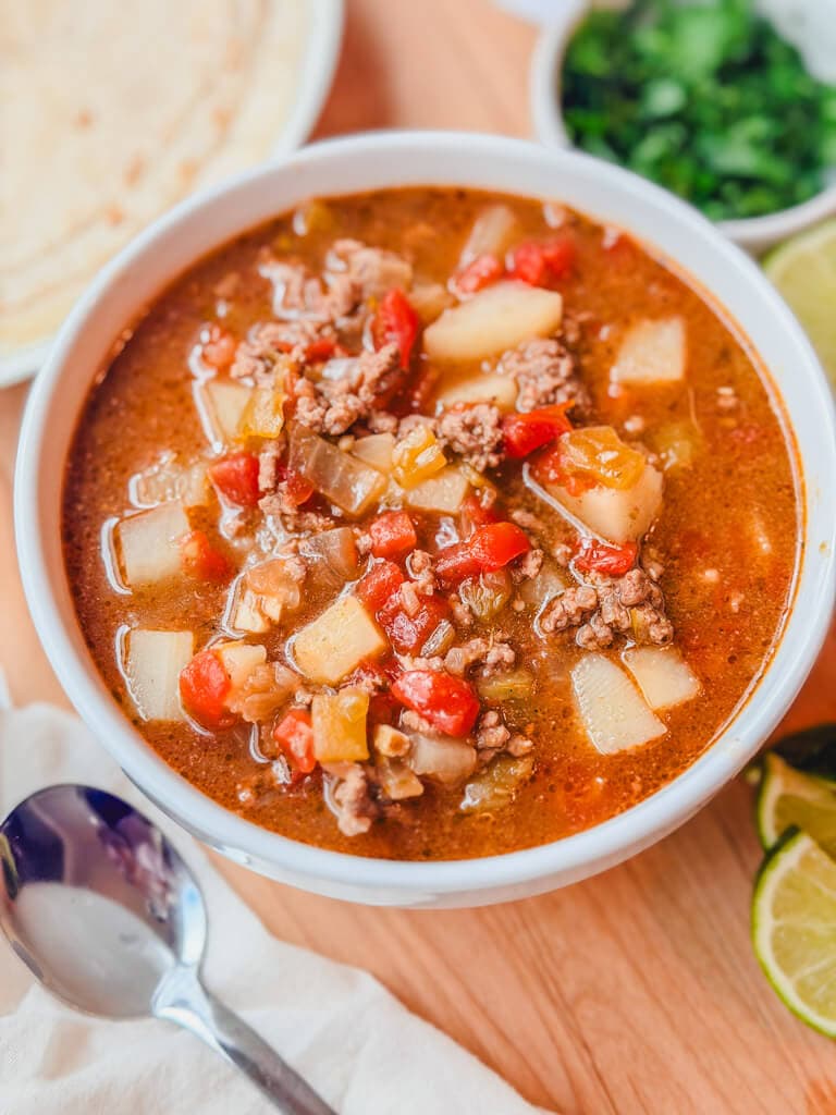overhead view of stew in a bowl with a soup spoon next to the bowl.