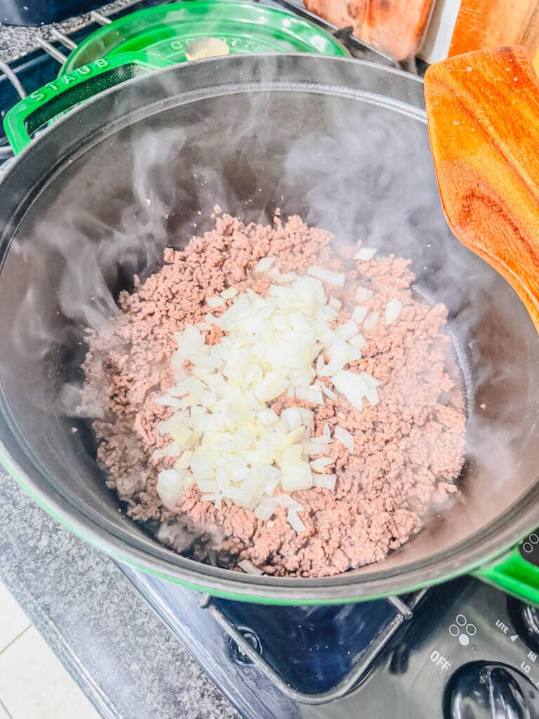 Diced onions added to the browned ground beef.