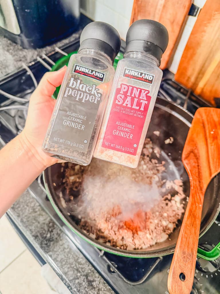 Salt and pepper bottles held over the large pot.