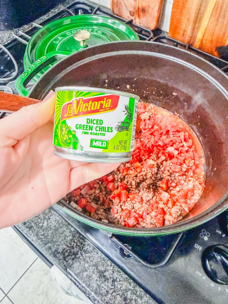 A small can of diced chiles about to be added to the large pot for ground beef chile stew recipe.