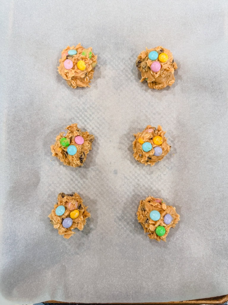 Overhead view of cookie dough balls on a prepared baking sheet.