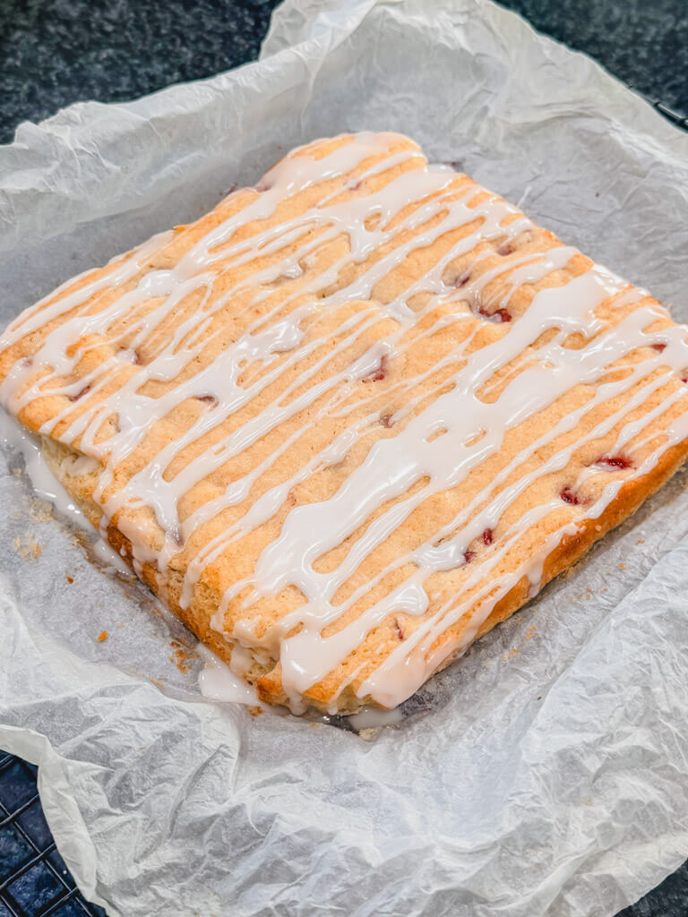 Strawberry Lemon Bars with Sweet Lemon Glaze ready to be cut and served.