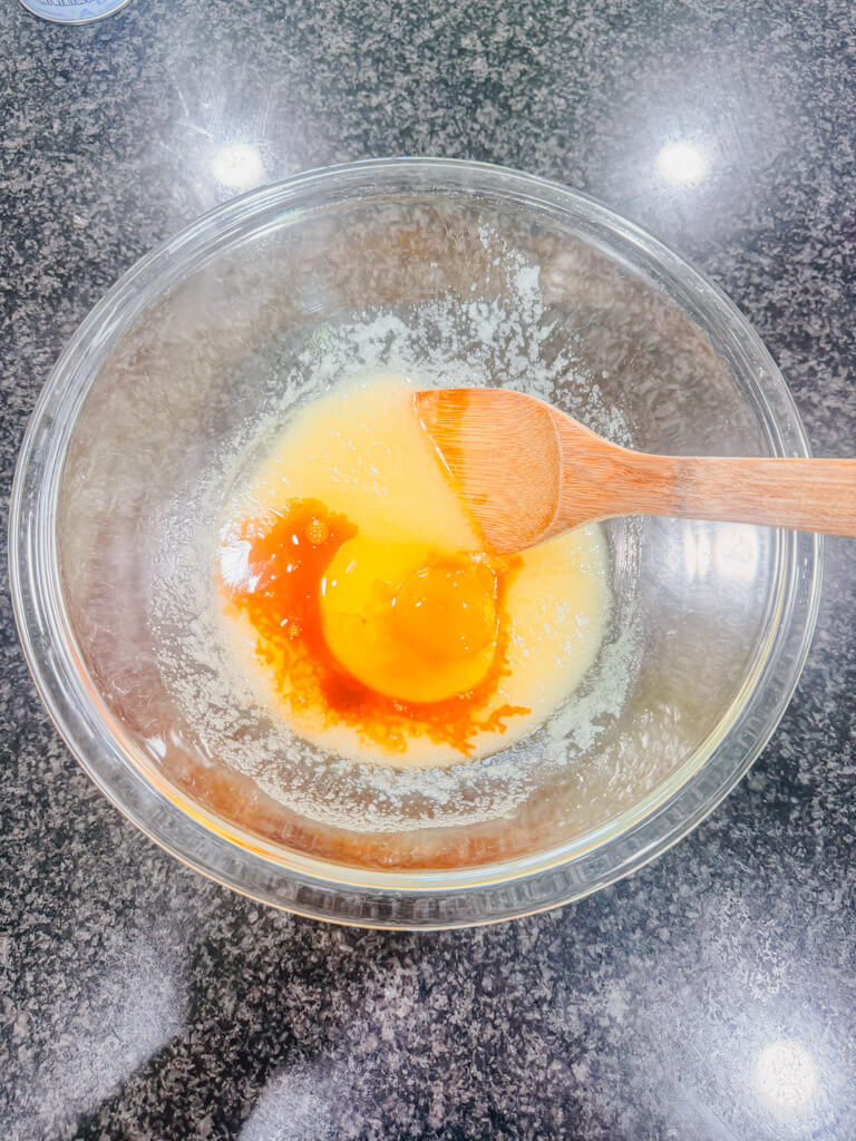 Vanilla extract added to the mixing bowl.