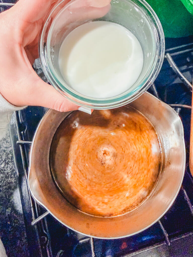 Cornstarch slurry poured into the teriyaki sauce that was in the saucepan on the stove.