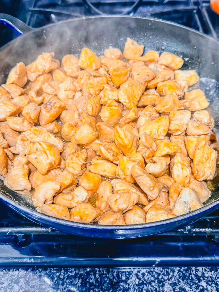 the teriyaki sauce thickening in the skillet with the chicken.