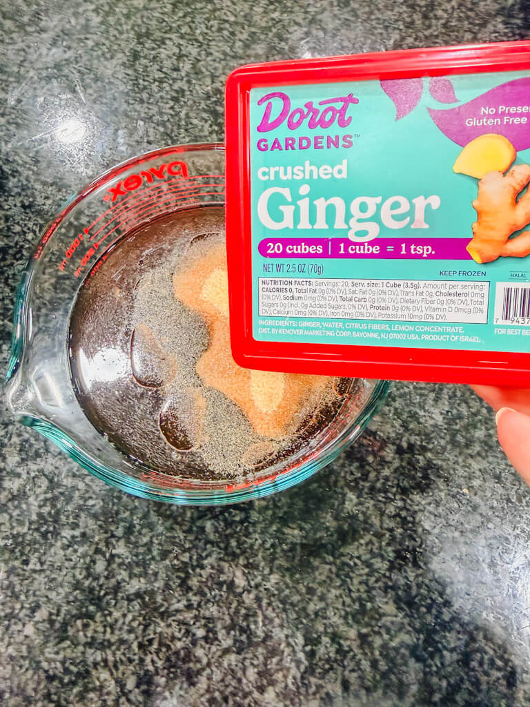 Ginger being added to homemade teriyaki sauce mixture