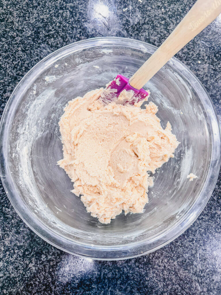 Lemon, vanilla, bean shortbread cookie dough in the mixing bowl ready to go into the fridge.