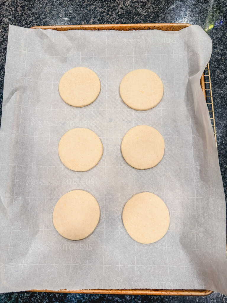 Cookie dough rounds placed onto the prepared baking dish, ready for the oven.