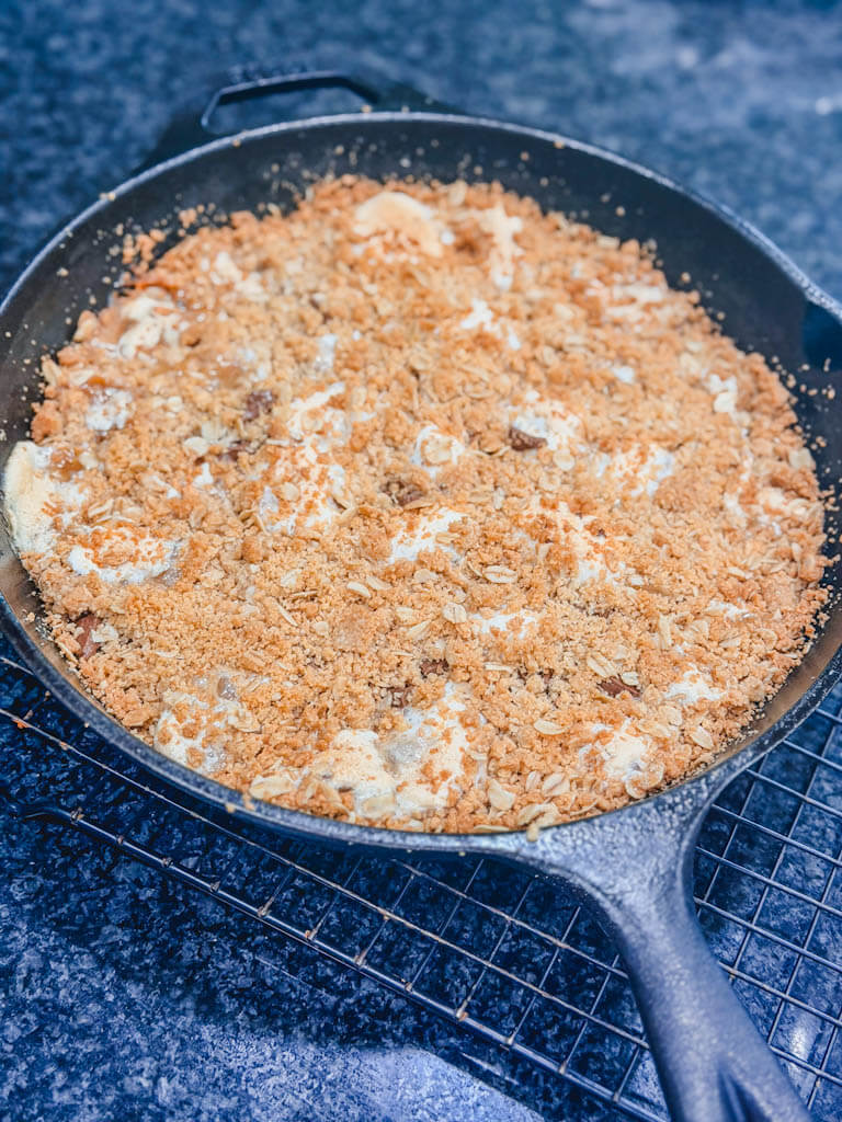 Cast Iron Skillet S'mores Pie baked until golden brown and cooling on a wire rack.