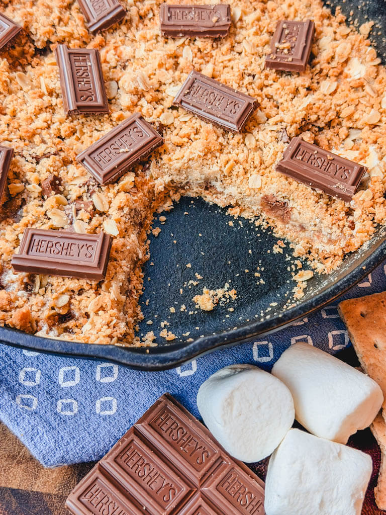 close up of Cast Iron Skillet S'mores Pie showing a serving taken out of the pie.