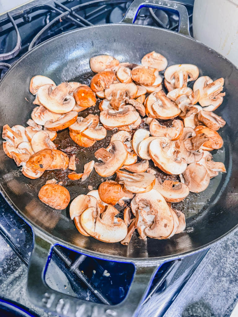 mushrooms being sauteed in the same skillet that the beef browned in.