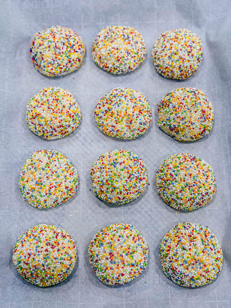 sprinkle sugar cookies resting on the baking sheet after baking in the oven.
