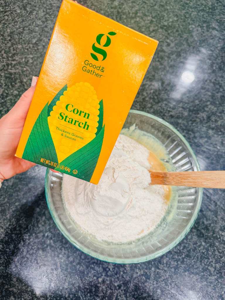 A box of cornstarch held over the mixing