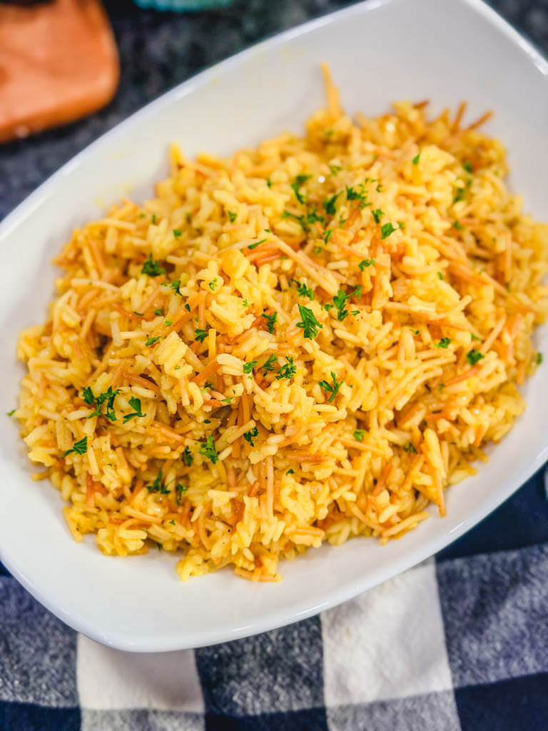 Close-up of fluffy homemade rice pilaf with toasted vermicelli and parsley.