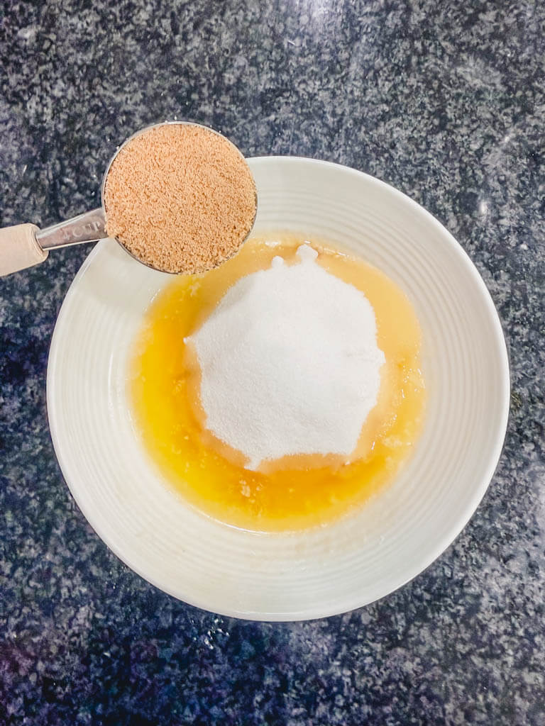 Brown sugar being added to the streusel topping ingredients.