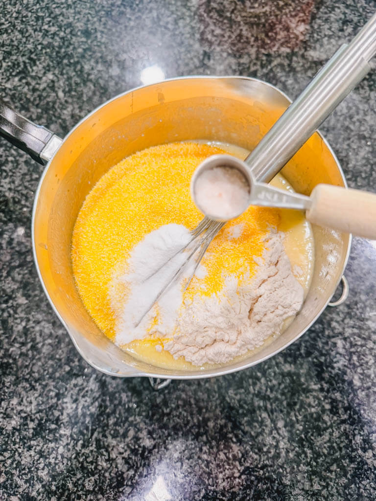 A small teaspoon of salt about to be added to the batter.