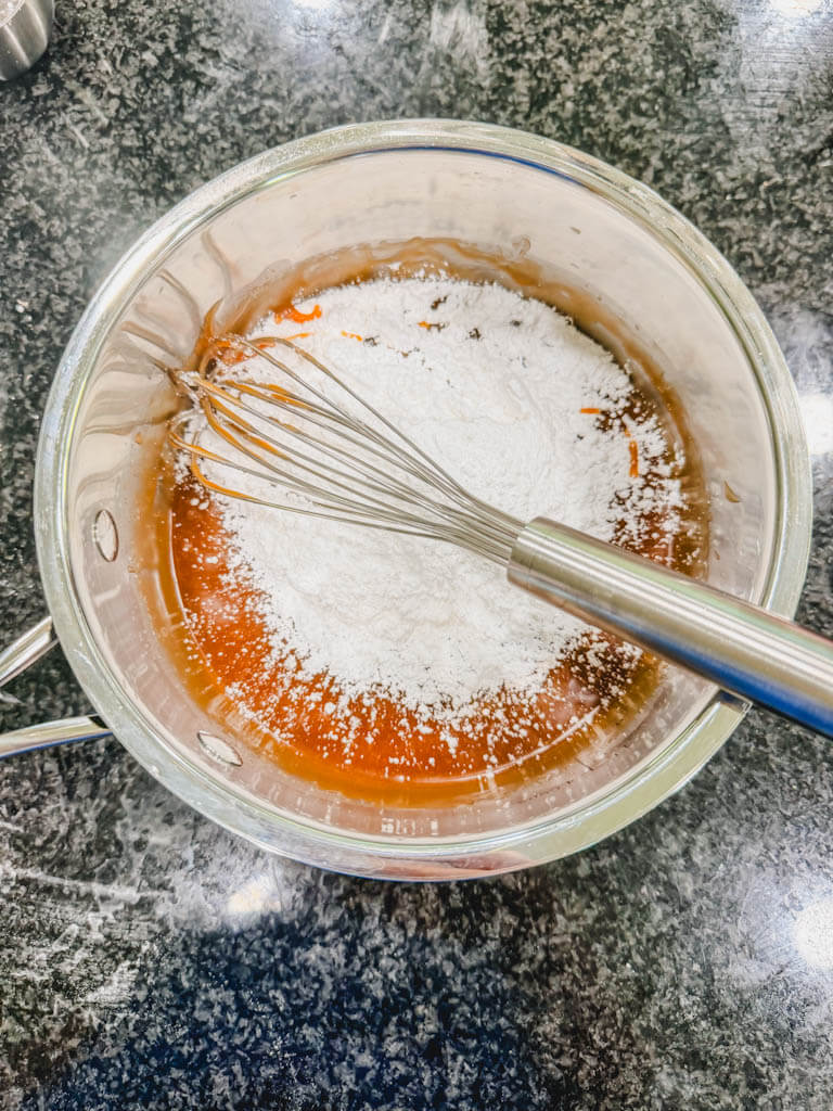 Powdered sugar added to brown sugar and Biscoff mixture to make thick banana bread icing.