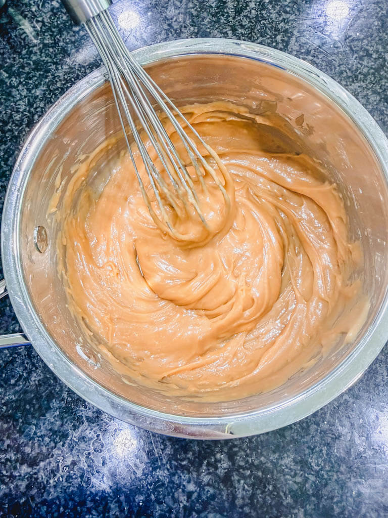 Thick brown sugar Biscoff icing whisked until smooth and creamy in a saucepan.