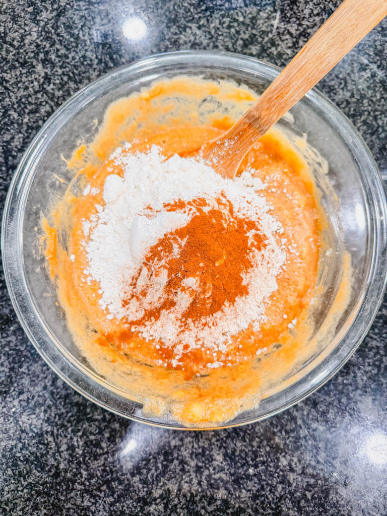 Baking powder, baking soda, salt, and cinnamon added to Biscoff banana bread batter.