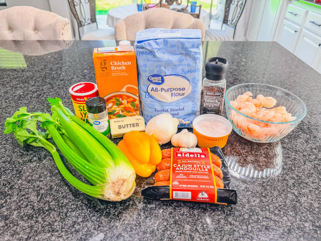 Ingredients for shrimp and andouille sausage gumbo arranged on a kitchen counter.