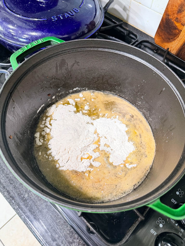 All-purpose flour added to melted butter in a Dutch oven to make gumbo roux.